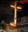 A cross of steel beams is left standing after the 9-11 WTC towers collapse. Click on the image for a larger image.