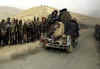 Click on this November 25th photo of Taliban prisoners driving by the NA front lines for a larger image.